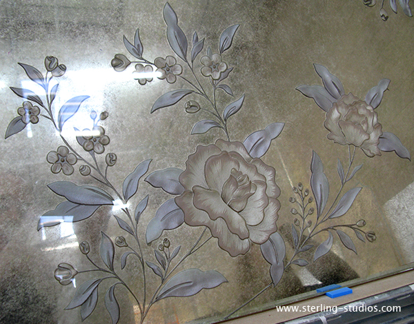 carved glass after painting and applying silver leaf to the background
