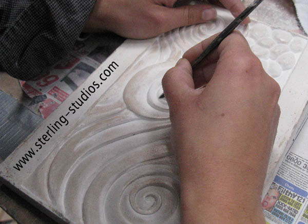 carving a plaster master to make a mould for casting resin